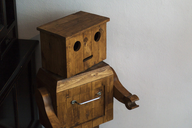 The wooden robot greets you